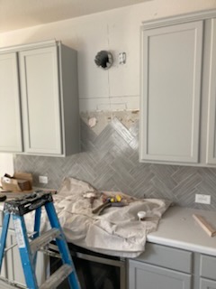 Herringbone tile backsplash installation